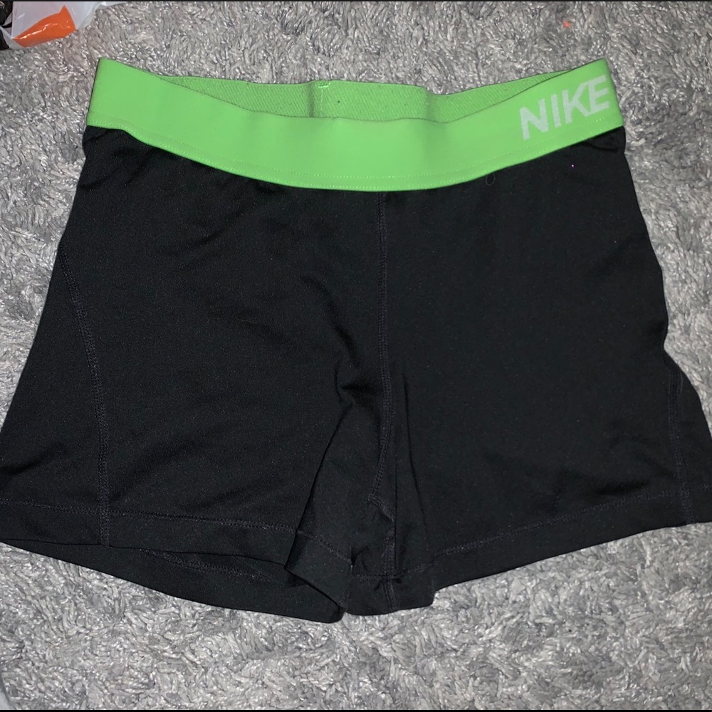 Black and green Nike pros